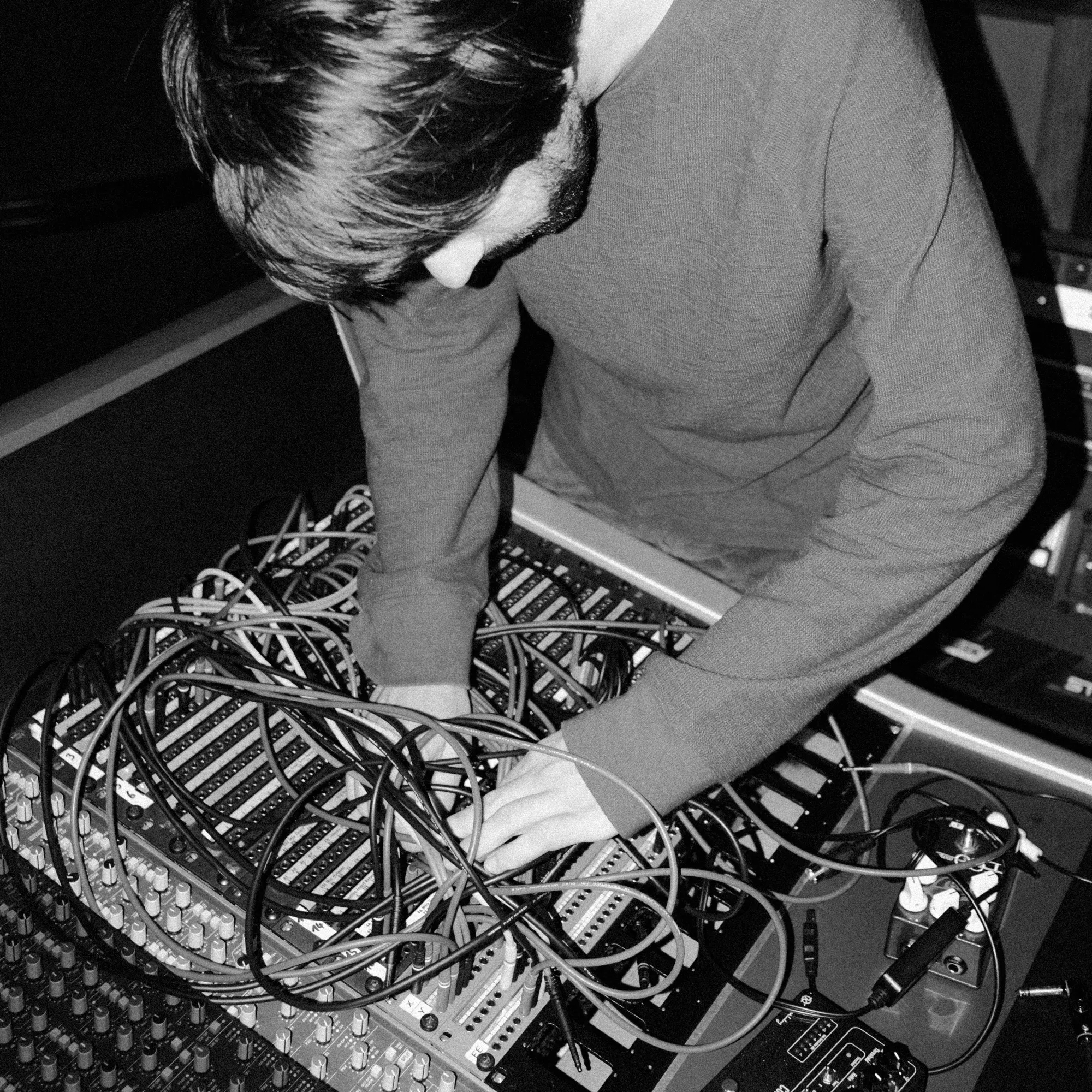 Oliver plugging in cables in a patchbay