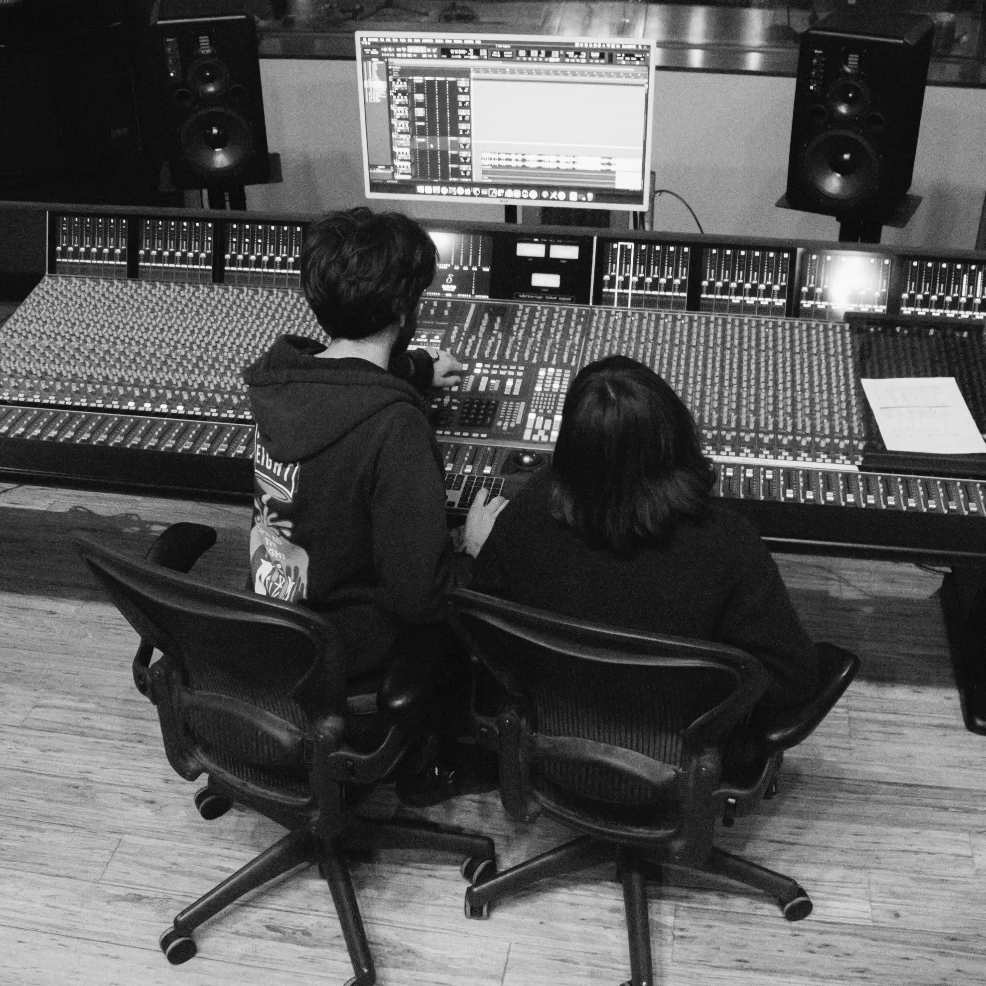 Oliver and girl working together in front of a recording console